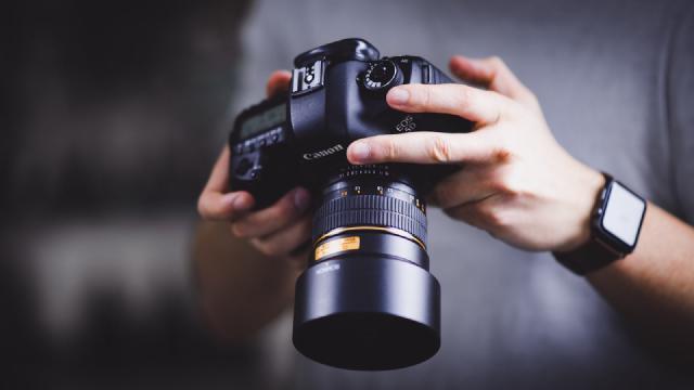 Photo of a man holding a Canon EOS 5D Mark III looking at the display on the back of the camera. Cover image for the blog post.